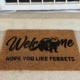 Welcome mat with an image of a ferret and the words, welcome, hope you like ferrets.